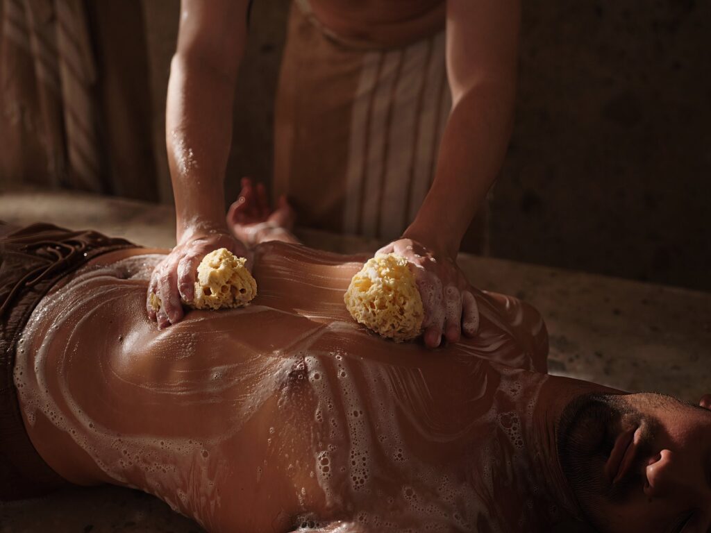 Hammam foam massage with natural sponges at Pietra Calda Spa